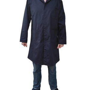 May include: A navy blue lab coat with long sleeves, a notched collar, and two large front pockets. The coat is worn over a pink and white striped shirt and blue jeans. The person is also wearing blue patterned shoes.