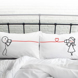 Adorable Say I Love You design on romantic couple pillowcases, showcasing two charming stick figures communicating through tin can phones. Whimsical I love you gift for her.