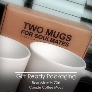 以下が含まれることがあります： 「TWO MUGS FOR SOULMATES」と書かれたギフトボックスと2つの白いコーヒーマグ。ボックスは茶色で、「SHARING LOVE SHARING ALL」の文字が入っています。画像には「Gift-Ready Packaging」、「Boy Meets Girl」、「Couple Coffee Mugs」の文字も含まれています。