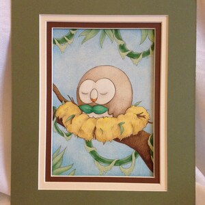 May include: A watercolor painting of a brown and white owl with closed eyes, sitting in a nest of yellow leaves. The owl is holding a green leaf in its beak. The background is a blue sky with green vines.