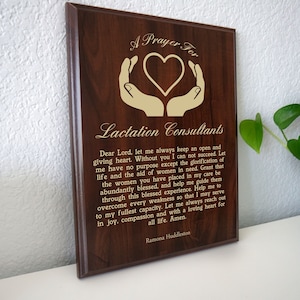 May include: A brown wooden plaque with a gold inscription that reads "A Prayer For Lactation Consultants". The inscription includes a prayer for lactation consultants, asking for guidance and strength to help mothers. The plaque is a beautiful and meaningful gift for a lactation consultant.