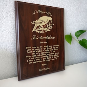 May include: A wooden plaque with a gold-colored bird and the text "A Prayer For Birdwatchers". The plaque features a poem about birdwatching and a prayer for peace and appreciation of nature.