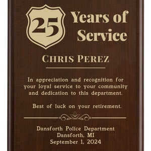 May include: A brown wooden plaque with gold lettering. The plaque reads "25 Years of Service" and "CHRIS PEREZ". The plaque also includes a message of appreciation and recognition for loyal service to the community and dedication to the department. The plaque is from the Dansforth Police Department in Dansforth, MI and is dated September 1, 2024.