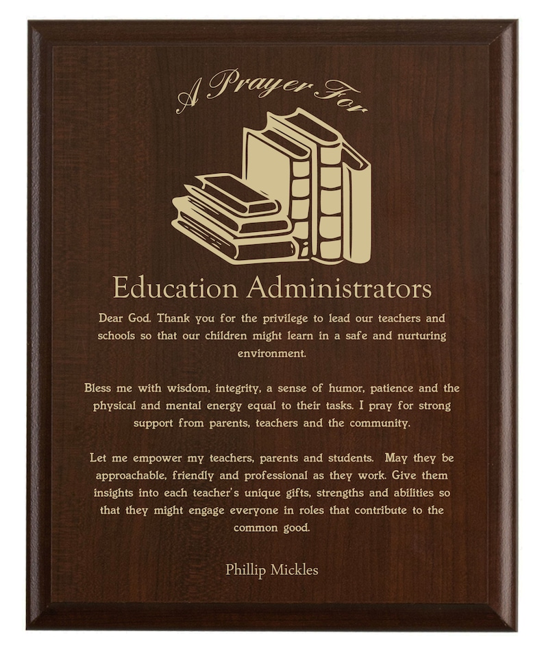 May include: A brown wooden plaque with gold lettering that reads "A Prayer For Education Administrators". The plaque features a stack of books and a prayer for education administrators.
