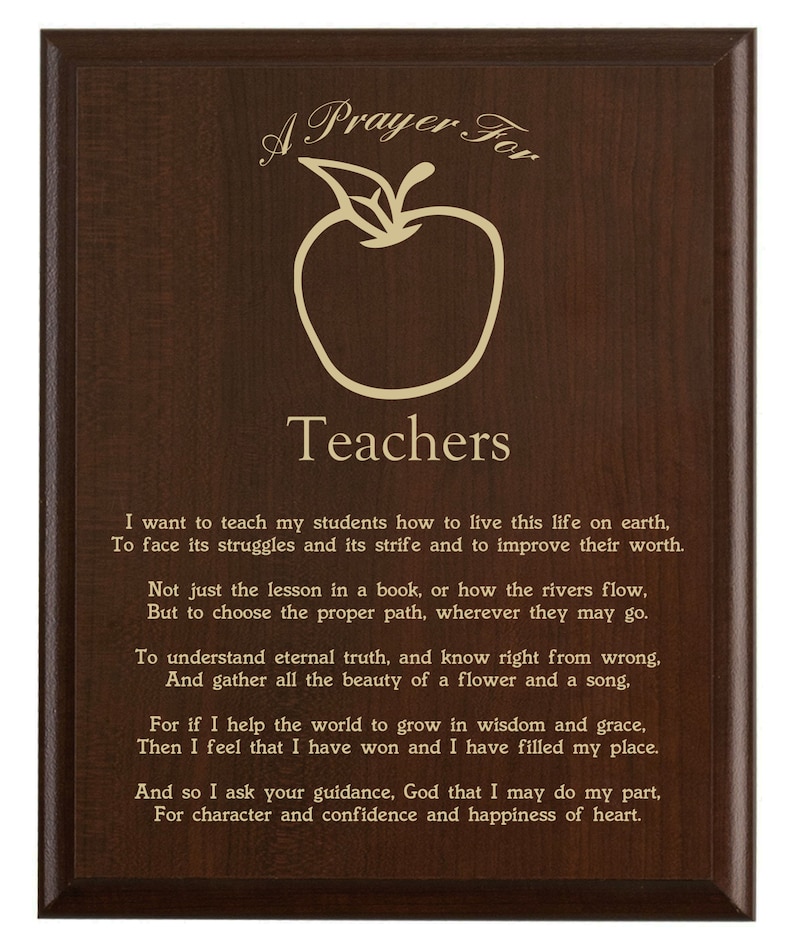 May include: A wooden plaque with a dark brown finish. The plaque features an apple graphic and the words "A Prayer For Teachers" in a decorative font. The plaque also includes a poem about teaching.
