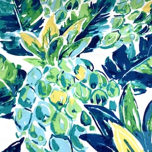 May include: A vibrant fabric pattern featuring a tropical design. The design showcases large, stylized leaves and clusters of fruit in shades of blue, green, and yellow against a white background. The artwork has a watercolor-like quality.