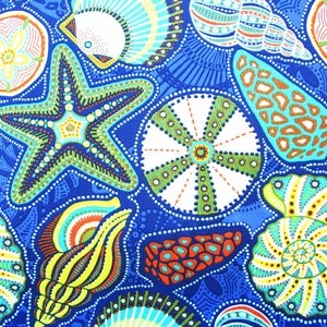 May include: A blue fabric with a colorful pattern of seashells, starfish, and sea urchins. The pattern is in shades of blue, green, yellow, orange, and red.