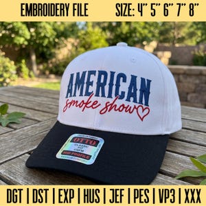 May include: A white baseball cap with a black brim featuring the embroidered text AMERICAN in blue block letters and smoke show in red cursive script with a red heart. A sticker on the brim reads OTTO CLASSIC FIT OSFM MID PROFILE.