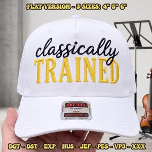 May include: A white baseball cap featuring the text "classically TRAINED" embroidered on the front. The word "classically" is in dark blue script, and "TRAINED" is in yellow block letters. A sticker on the brim reads "OTTO CLASSIC".