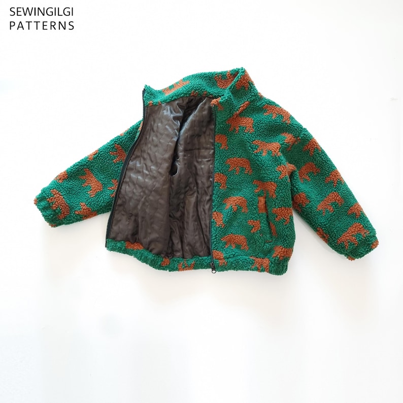 May include: A green and brown bear-patterned fleece jacket with a high collar, long sleeves, and a black zip closure. The interior is lined with a smooth dark brown fabric. The text SEWINGILGI PATTERNS is visible in the top left corner.