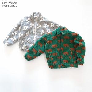 May include: Two zip-up fleece jackets with stand-up collars and front pockets. One jacket is grey with a white cherry pattern, and the other is green with a brown bear pattern. The text SEWINGILGI PATTERNS is visible in the top left corner.