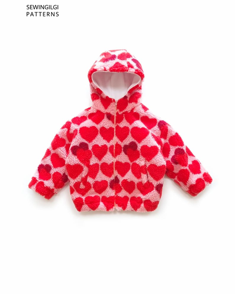 May include: A hooded jacket made of pink and red heart-patterned fleece material with a front zip closure. The text SEWINGILGI PATTERNS is visible in the upper left corner. The jacket features long sleeves and a white interior lining.