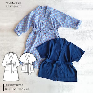 May include: Two robes are shown: a light blue floral patterned robe and a navy blue solid robe. Both robes have a wrap-around design and a belt. The image also includes line drawings of the robe and text that reads "SUNSET ROBE KIDS SIZE 80~150cm". The text "SEWINGILGI PATTERNS" is also visible.