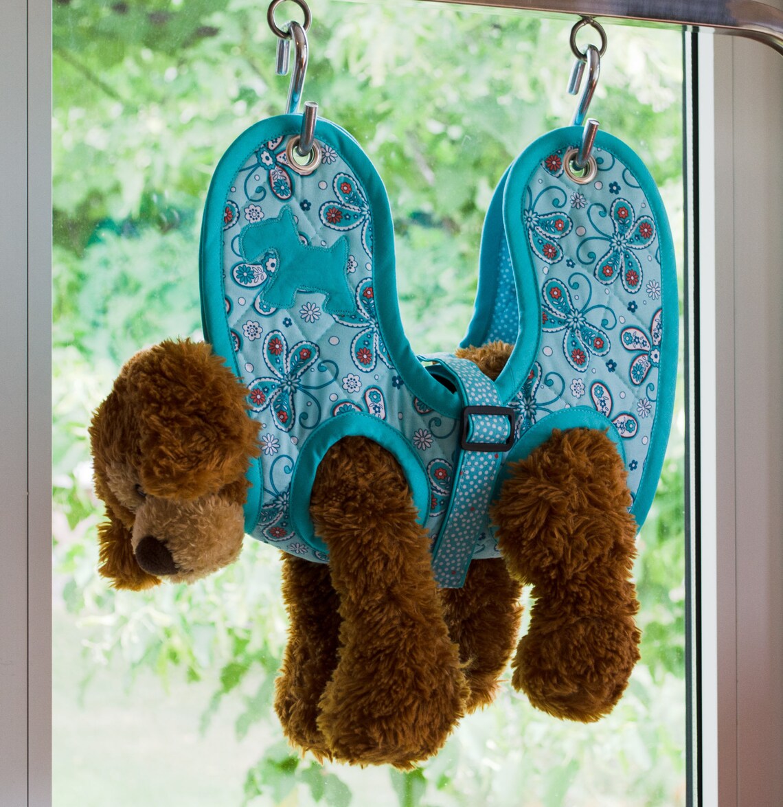Aqua-colored hammock-style grooming sling for small dogs