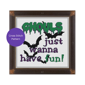 May include: Cross stitch pattern with the text "Ghouls just wanna have fun!" in green and purple lettering. The design features four black bats with purple accents.