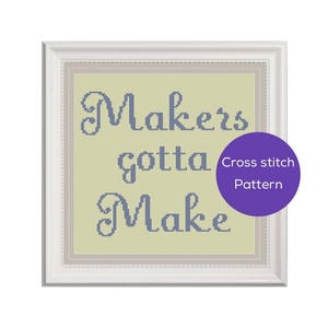 May include: A cross stitch pattern with a white background and a blue inscription that reads "Makers gotta Make".