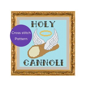 May include: Cross stitch pattern of a cannoli with angel wings and a halo, framed in gold. The words "HOLY CANNOLI" are above and below the cannoli. A purple circle with the words "Cross stitch Pattern" is in the upper left corner.