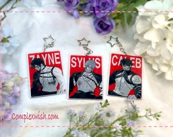 May include: Three red and white keychains with black and white illustrations of characters. The keychains feature the names "Zayne", "Sylus", and "Caleb".