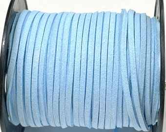 May include: A spool of light blue suede cord. The cord is wound tightly around the spool and is ready to be used for crafting projects.