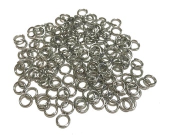 May include: A large pile of silver jump rings. The rings are small and round, and they are all linked together.