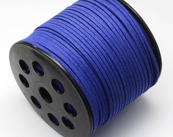 May include: A spool of royal blue suede cord, wound around a black plastic bobbin with holes for dispensing the cord.
