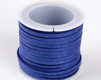 May include: A spool of dark blue suede cord, wound around a white plastic bobbin.
