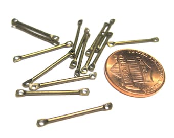 May include: A group of 15 antique gold-toned metal jump rings, each with a small loop at both ends. The rings are approximately the size of a US penny.