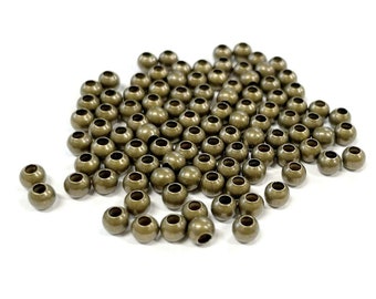 100 billes d'espacement rondes, bronze antique lisse, 4 mm (n° BZSP558)