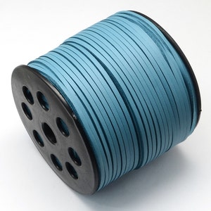 May include: A spool of light blue leather cord wound around a black plastic spool. The cord is smooth and has a subtle sheen.