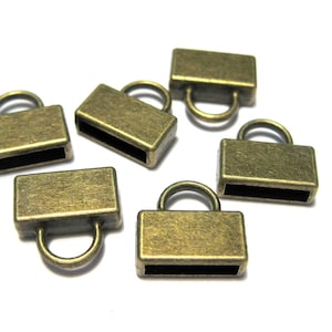 May include: Six antique gold-toned metal end caps with a loop on top. The end caps are rectangular with a small opening on the side.