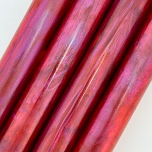May include: Three red and purple iridescent acrylic rods.