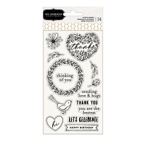 May include: Clear acrylic stamps with black line art designs. Includes floral wreaths, a heart with "thanks", a bird, and phrases like "thinking of you", "let's celebrate", and "happy birthday". The package has the text "JEN HADFIELD HOME + MADE".