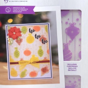 May include: A Gemini 2-piece embossing folder set. The package features a sample card with embossed Christmas ornaments and the words "ho ho". The folder size is 5" x 5" (12.7cm x 12.7cm). The package also includes a clear embossing folder with a Christmas ornament design.