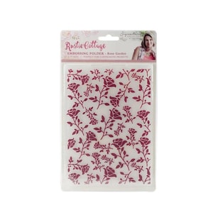 May include: A clear plastic embossing folder with a burgundy rose garden design. The folder is labeled "Rustic Cottage" and "Rose Garden". The embossing folder is designed for cardmaking projects.
