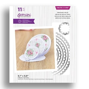 May include: A Gemini Create-a-Card set featuring triple easel circles. The set includes papercraft dies and pre-printed floral patterned circles. The largest circle measures 5.1 inches by 5.0 inches.