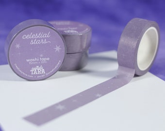 May include: Purple washi tape with a celestial stars design. The tape is 15mm wide and 10m long. The tape is packaged in a clear plastic roll with a label that says "celestial stars" and "creativelytara.com".