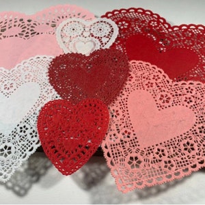 Peut inclure: Assortiment de napperons en dentelle en forme de c&oelig;ur en rose, blanc et rouge. Les napperons sont faits de dentelle d&eacute;licate et ont un bord festonn&eacute;.