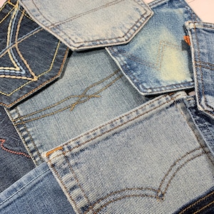 May include: A patchwork of different denim fabrics, each with unique stitching and wear patterns. The fabrics are arranged in a random pattern, creating a visually interesting and textured surface.
