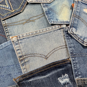 May include: A patchwork of denim fabric in various shades of blue, with some pieces featuring stitching and embroidery. The fabric is arranged in a random pattern, creating a unique and textured look.