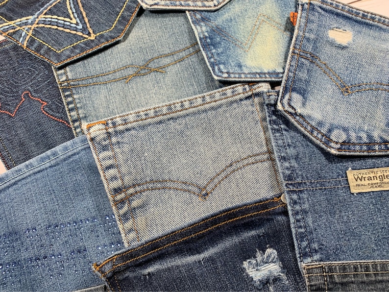 May include: A patchwork of denim fabric in various shades of blue, with some pieces featuring stitching and embroidery. The fabric is arranged in a random pattern, creating a unique and textured look.