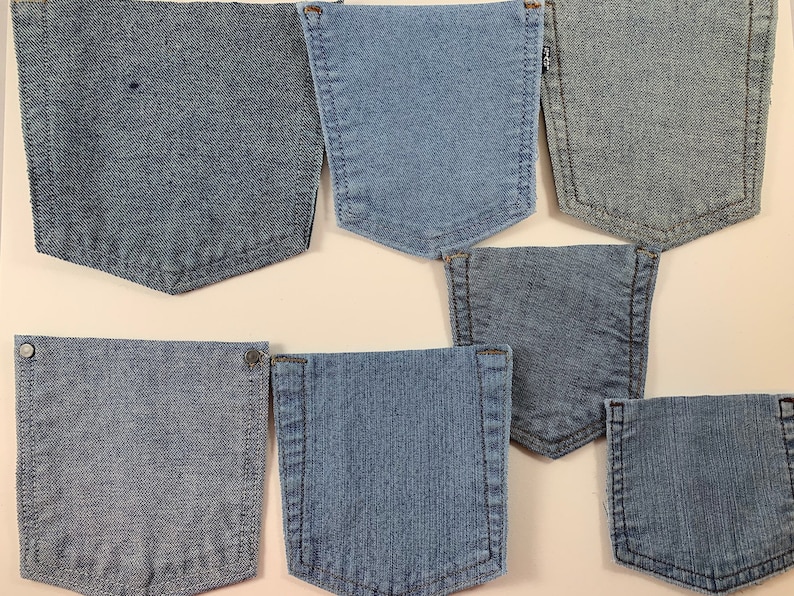 May include: Eight different denim fabric swatches, each showing a different weave and shade of blue. The swatches are arranged in two rows of four, with the top row showing a lighter shade of blue and the bottom row showing a darker shade of blue.