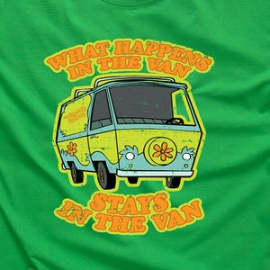 May include: Green t-shirt featuring a cartoon van and the text "What happens in the van stays in the van".