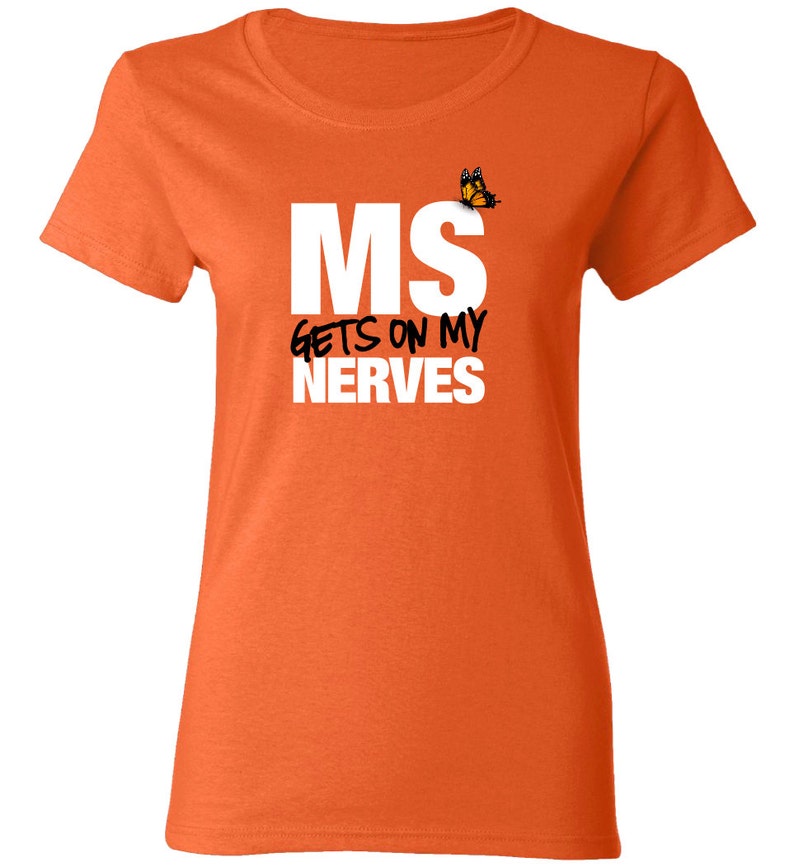 May include: Orange t-shirt with white text that reads "MS gets on my nerves" and a small butterfly graphic.