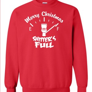 May include: Red Christmas sweatshirt with a white graphic of a toilet gauge that reads "Merry Christmas Shitter's Full".