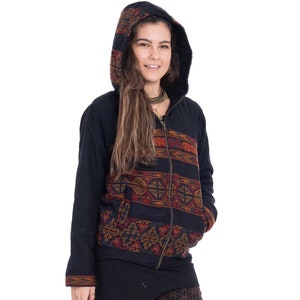 May include: A black hooded jacket with a colourful geometric pattern. The jacket has a zip closure and a drawstring hood. The model is wearing black leggings with a geometric pattern.
