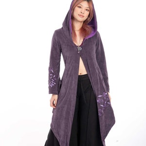 May include: A long, purple hooded cardigan with a light purple trim and floral embroidery. The cardigan is open in the front and has a relaxed fit.