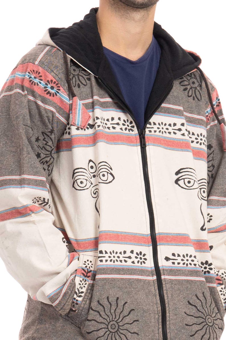 May include: A gray and white hooded jacket with a black zipper and a patterned design. The pattern includes red, blue, and black stripes, as well as stylized eyes and floral motifs.