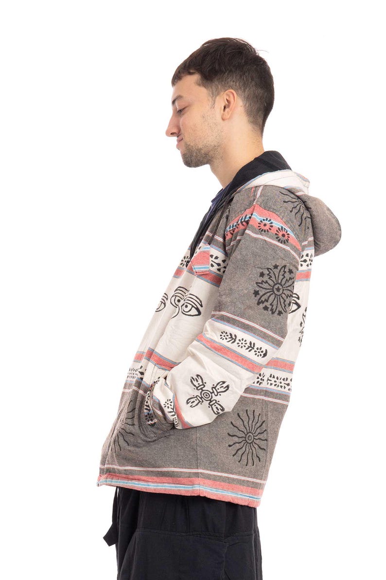 May include: A hooded jacket with a white and gray striped pattern and black and white geometric designs. The jacket has a zipper closure and a drawstring hood.