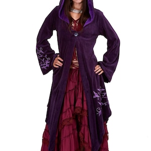 May include: A deep purple hooded coat featuring long flared sleeves, a single front button closure, and light purple vine embroidery on the sleeves and hem. The coat is worn over a dark red tiered skirt with lace trim and a matching lace-up top.