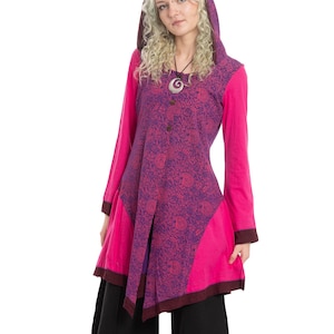 May include: A hooded tunic in shades of pink and purple, featuring a floral pattern on the bodice and sleeves. The tunic has a unique asymmetrical design and is paired with black palazzo pants. The outfit is suitable for casual wear.